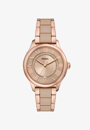 Orologio rosa oro con cassa rotonda, cinturino in silicone beige, numeri romani su un quadrante in tonalità oro con texture e display della data alle 6.