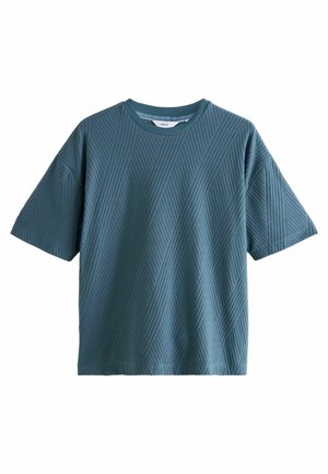 Kortærmet, teal t-shirt lavet af tekstureret stof. Har et diagonalt ribbet mønster og en rund halsudskæring. Lige snit, afslappet pasform.