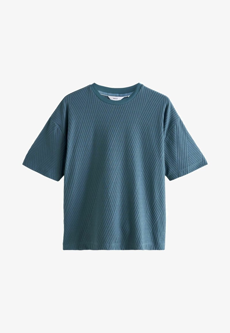 Lühikeste varrukatega, türkiissinine t-särk, mis on valmistatud tekstureeritud kangast. Omab diagonaalset ribapakendit ja ümmargust kaelust. Sirge lõige, lõdva istuvusega.