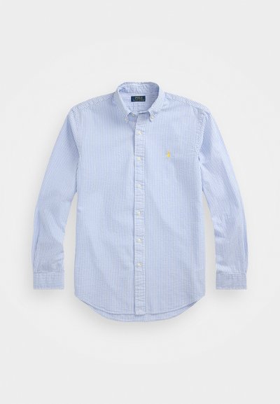 Camisa de botão em azul e branco às riscas, feita de algodão. Apresenta um colarinho clássico, mangas longas e um pequeno logotipo bordado no peito.