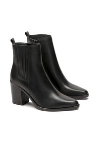 Mustad nahast pahkluu saapad terava ninaga, ploki kontsaga ja vertikaalsete elastsete külgpaneelidega. Sile struktuur minimaalsete riistadega.