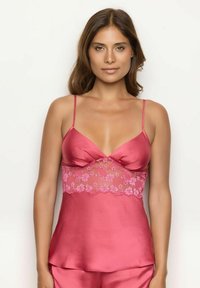 Satijnen topje in rozenpink met verstelbare spaghettibandjes en kant-inzetdetails bij de borsten. Zachte textuur en een relaxte pasvorm.
