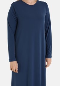 Navy blue long-sleeve dress made of soft, smooth fabric with a round neckline and subtle stitching details on sleeves and hem.
