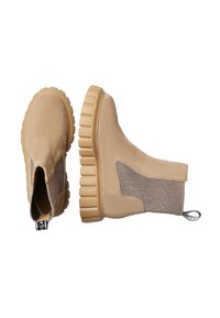 Botas de tobillo beige con un upper de tela texturizada, paneles elásticos a los lados y una suela de goma gruesa y estriada. Tirador en la parte trasera para facilitar el calzado.