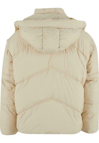 Beige puffer jacket with a hood, featuring chevron stitching and a soft, quilted texture, designed for warmth and comfort.