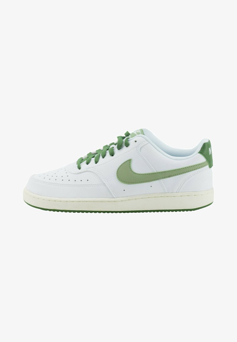 White leather sneaker with green accents, flat laces, perforated toe, and a rubber sole. Features a visible brand logo on the heel.