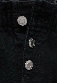 Črn jeans material z visokim pasom, s tremi srebrnimi pritisnimi gumbi na vrhu in vidnimi šivi.