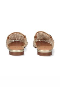 Sandalias de oro trenzadas con un diseño de talón abierto, plantilla color tostado y parte superior texturizada con un brillo sutil. Suela de goma plana de color marrón claro.