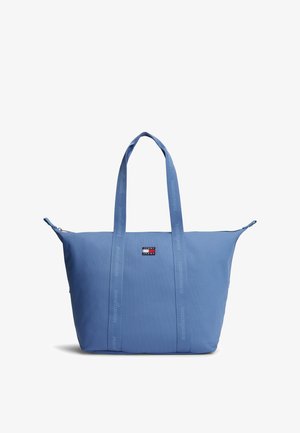 Hele sinine kandekott kahe pika sangaga ja Tommy Jeans'i logoga märgisega esiküljel keskel.
