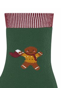 Zielona dzianinowa skarpetka z bordowym, prążkowanym mankietem. Posiada haftowanego piernikowego ludzika w żółtej koszulce z białymi detalami.