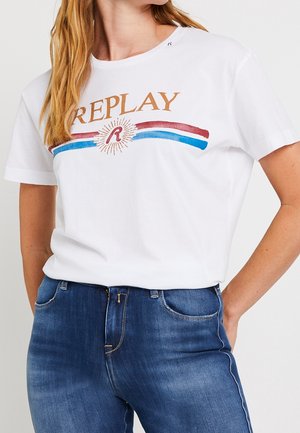 Biała bawełniana koszulka z napisem "REPLAY" w złotych literach, pod którym znajdują się czerwone i niebieskie paski oraz ozdobna grafika promieni słonecznych.