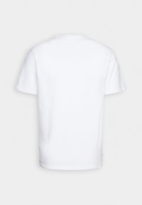 T-shirt en coton blanc à manches courtes, col rond et dos uni. Texture douce et design simple, idéal pour un style décontracté.