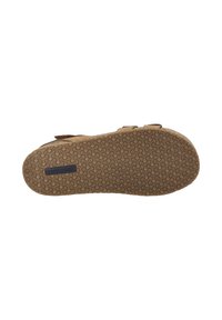 Sandale en suede marron avec une semelle en caoutchouc texturée présentant un motif tourbillonnant et une étiquette logo, conçue pour le confort et la durabilité.