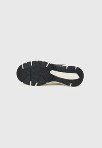 Sneaker sole with a black rubber tread pattern and white midsole. Features textured grip and ridged accents for traction.