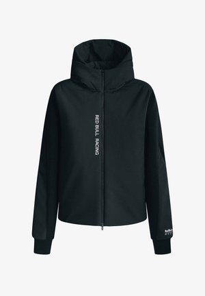 Črna kapuca jakna z zadrgo spredaj. Vsebuje "RED BULL RACING" v beli navpični pisavi na eni strani. Narejena je iz gladkega, lahkega materiala.