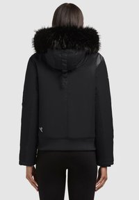 Black puffer jacket with a large faux fur hood, ribbed hem, and slightly cropped design. Smooth exterior with a minimalist aesthetic.