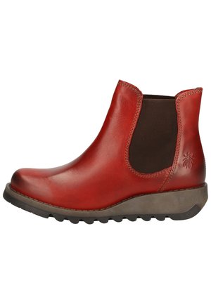Red leather ankle boot with elastic side panels, round toe, and textured rubber sole. Features subtle branding on the outer side.