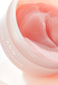 Patch oculaire rétinien Abib PDRN dans un contenant rose transparent ; présente des patchs gélatineux texturés de forme incurvée.