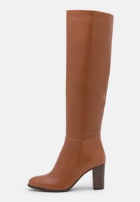 Tall brown leather boots with a sleek design, rounded toe, and a block heel. Smooth texture and minimal stitching details visible.