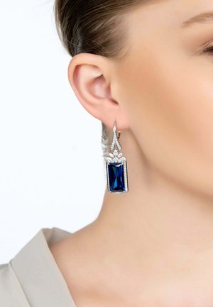 Blue rectangular gemstone earrings with silver accents, featuring a sparkling design and detailed prong settings.