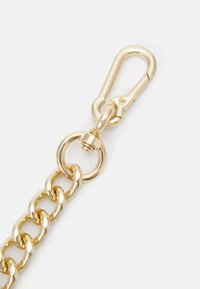 Gold metal chain with a large link design, featuring a lobster claw clasp and a circular ring attachment. Smooth, shiny surface finish.