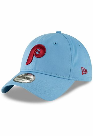 Light blue baseball cap made of fabric with a curved brim. Features a red embroidered logo and a circular tag on the visor.