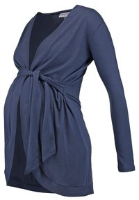 Marinfärgad långtärmad gravid topp i mjukt tyg, med en inlindad design och knut framtill samt draperad nederkant för justerbar passform.