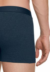 Boxer in blu navy realizzati in materiale morbido e elastico, con una vita liscia impressa con la scritta "FALKE" e una vestibilità aderente.
