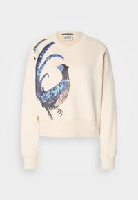 Sudadera corta de color crema con una ilustración de un pájaro colorido en el frente. Presenta puños y dobladillo acanalados, fabricada en una tela suave.