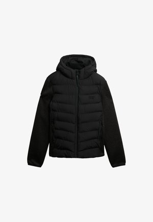 Puffjacke mit Kapuze, bestehend aus einer schwarzen gesteppte Vorderseite und dunkelgrauen gestrickten Ärmeln. Mit Reißverschluss und seitlichen Taschen.