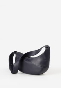 Borsa a tracolla in pelle blu navy con forma asimmetrica, ampia tracolla e superficie liscia. Presenta una chiusura superiore con zip per una chiusura sicura.