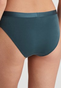 Dark teal high-waisted briefs made from soft, smooth fabric with a seamless waistband and leg openings, featuring minimal stitching detail.