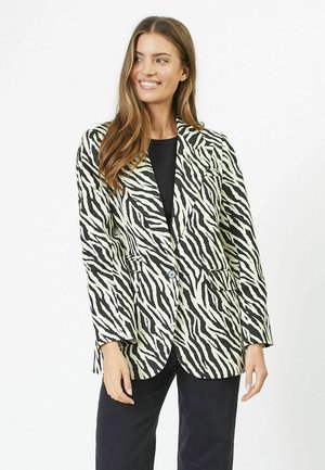 Black and white zebra-striped blazer with a single button closure, two front pockets, and a tailored fit. Smooth fabric texture.