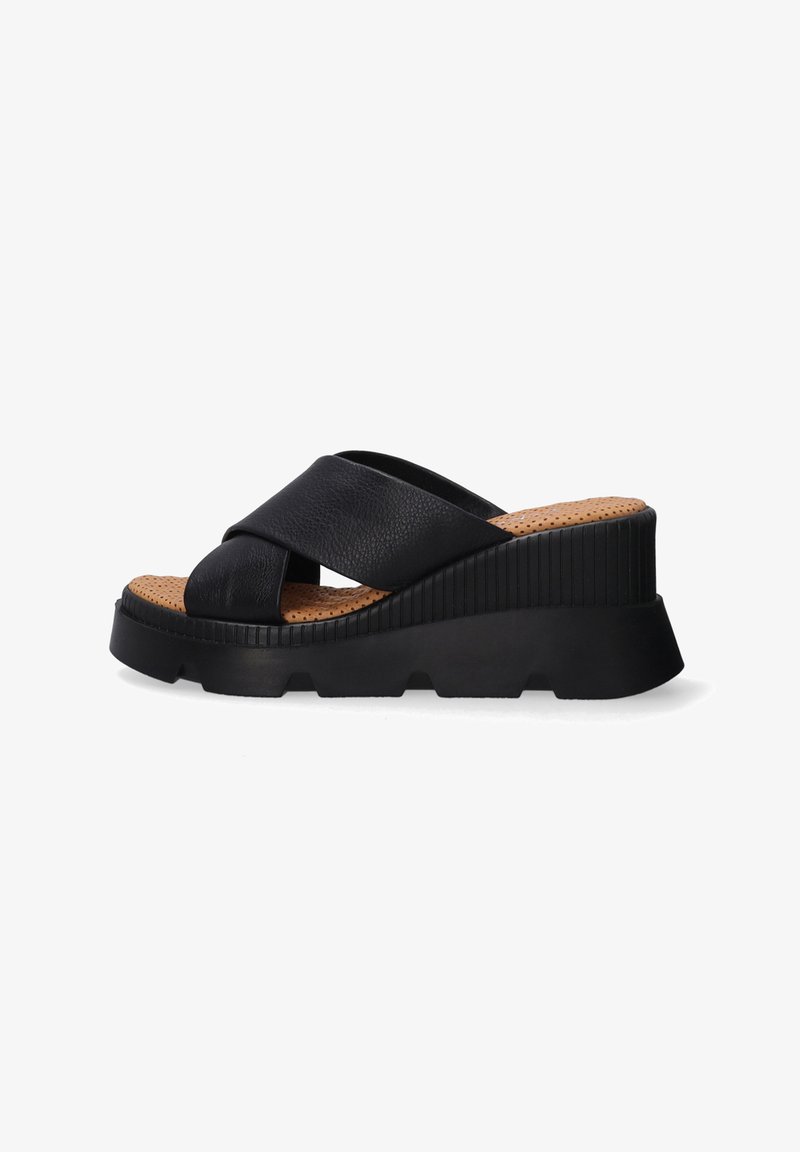 Black leather wedge sandals featuring a cross-strap design, textured cork footbed, and a rubber outsole with a ridged pattern.