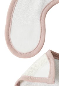 Cotton makeup remover pads, featuring a soft white terry surface and pink stitched edges. Round shape, lightly textured finish.