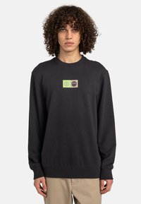 Black sweatshirt with a crew neck, featuring a green and beige rectangular graphic on the chest. Made from soft, textured fabric.