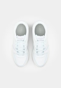 Light blue and white sneakers with a mesh upper, perforated texture, round toe, and standard laces. Subtle logo on the tongue.