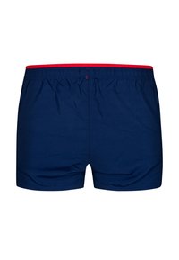 Miesten uimapuvut tummansinisellä värillä, jossa on punainen joustava vyötärö, valmistettu kevyestä kankaasta. Uimapuvut ovat klassisen laatikkomainen malli ja sileä tekstuuri.