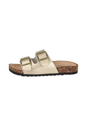 Sandalia beige tipo slide con dos hebillas ajustables en tono dorado, plantilla de corcho y suela negra texturizada, vista de lado.