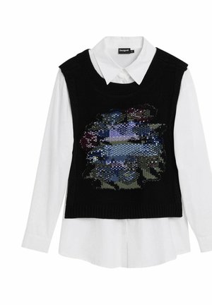 Schwarze gestrickte Sweaterweste mit einem farbenfrohen, mit Pailletten besetzten abstrakten Design, das über einem weißen Hemd mit Kragen getragen wird. Lange Ärmel sind sichtbar.