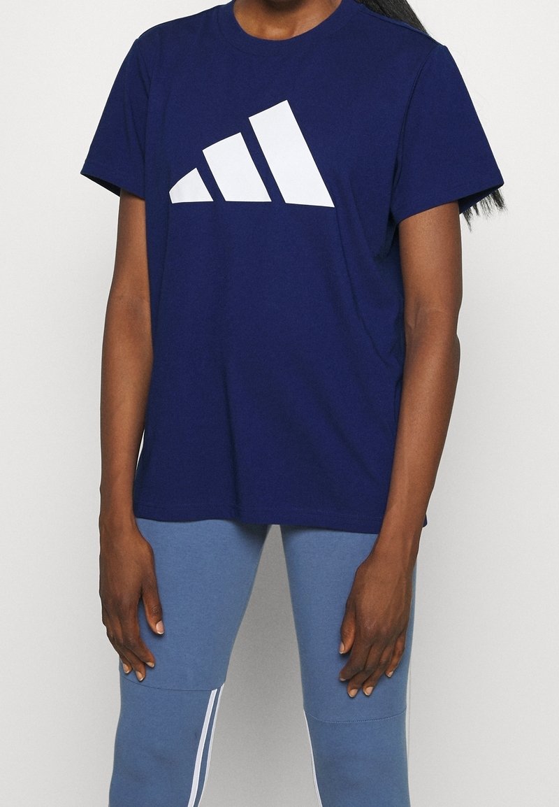 Navy cotton t-shirt featuring a large white striped logo on the front. Short sleeves and a crew neckline. Smooth fabric texture.