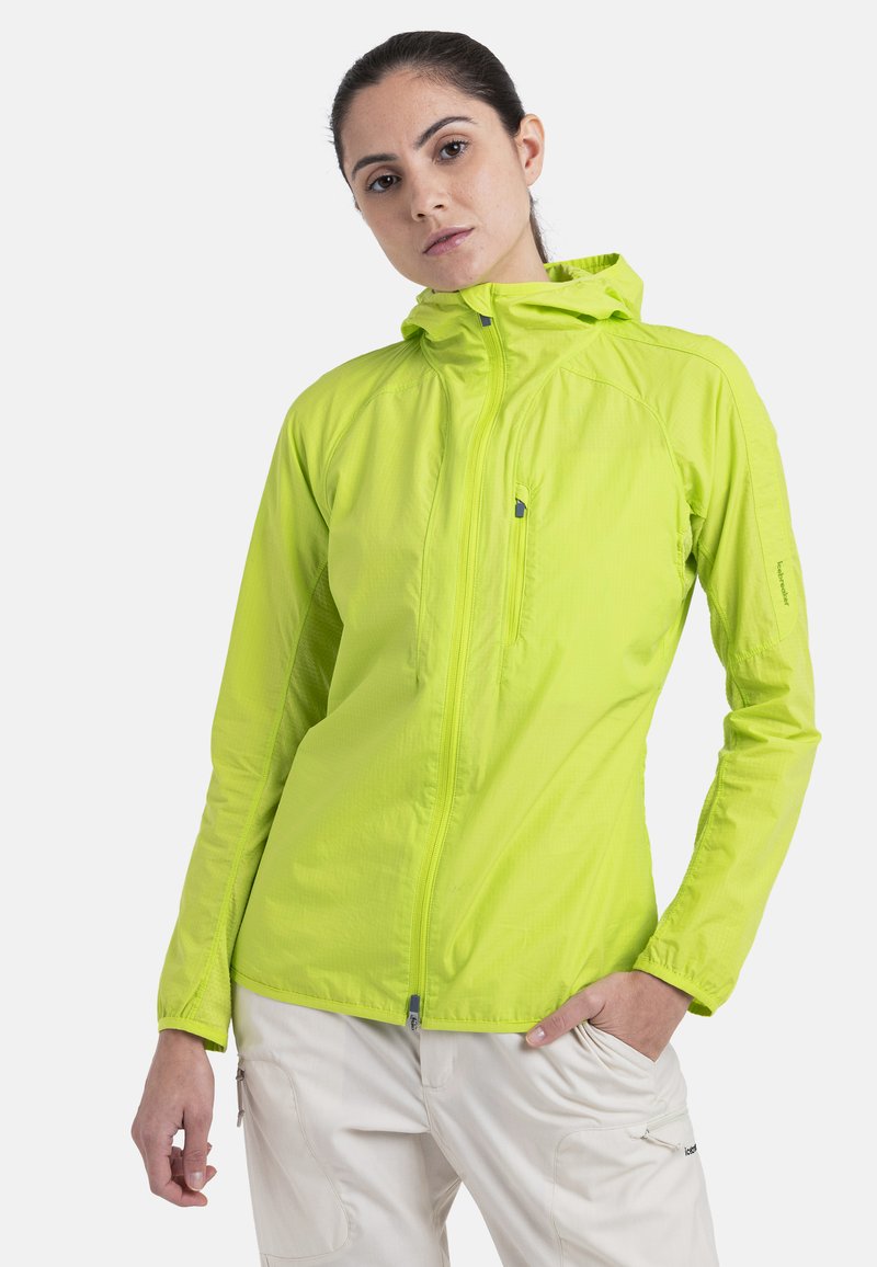 Leichte gelb-grüne Jacke mit Kapuze, Reißverschluss vorne und strukturiertem Stoff. Verfügt über eine Reißverschlusstasche auf der Brust und verstellbare Manschetten.