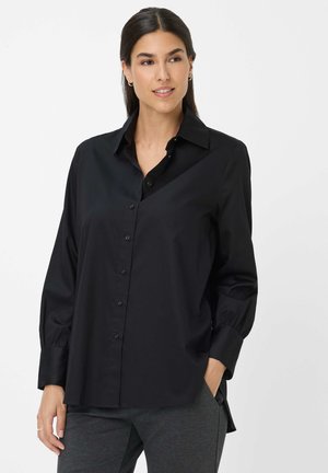 Black button-up shirt with a collared neckline, long puff sleeves, and a smooth texture. Curved hem and subtle button details.