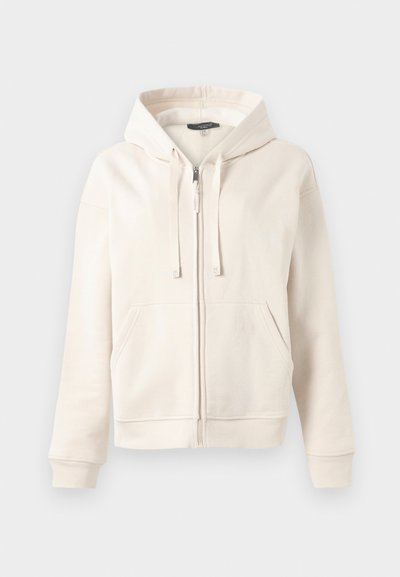 Cream-colored zip-up hoodie with front pockets, drawstring hood, and ribbed cuffs and hem against a plain light background.