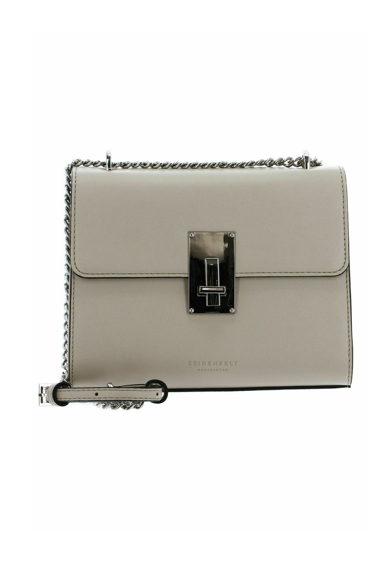 Sac à main en cuir beige de forme rectangulaire, avec rabat avant, ferrures argentées et bandoulière chaîne. Comprend un détail de fermoir central et un logo.