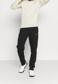 Champion Teplákové kalhoty - black