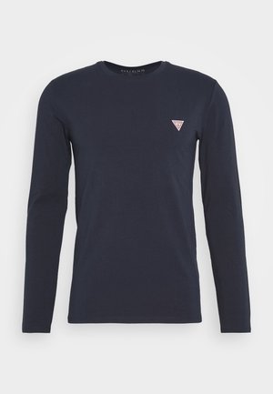 Granatowy, długi rękaw, koszulka z okrągłym dekoltem i małym trójkątnym logo Guess na lewej piersi.