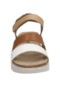 Open-toe sandal featuring three straps in beige, brown, and white. Textured footbed and a cork-like sole provide comfort and support.