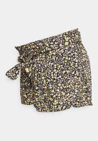 Květinové šortky s černým pozadím a žlutými a fialovými květinami, s elastickým pasem a detailem se zavazováním na boku. Lehký materiál.