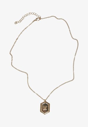 Arany színű nyaklánc finom lánccal, hatszögletű medállal, amelyen az "M" betű és dekoratív szegély található.